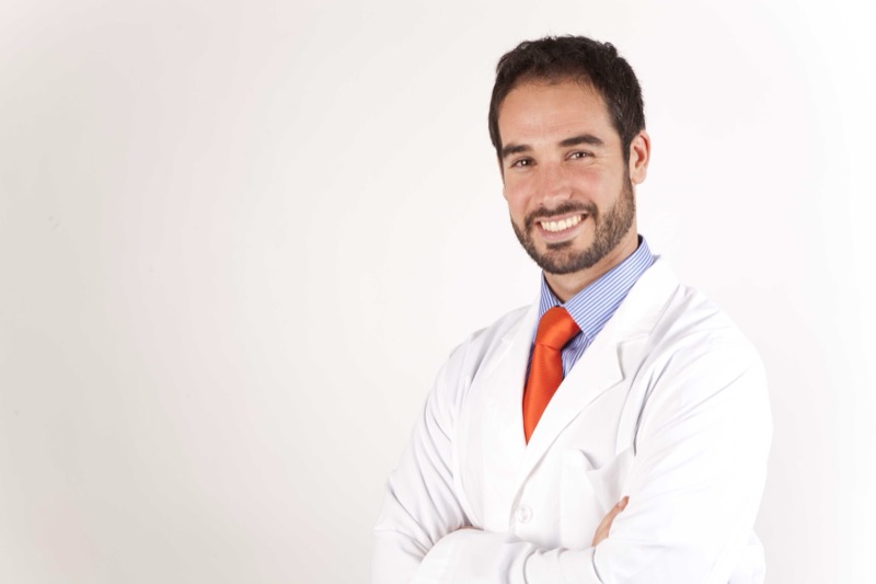 Dr. Sergio Calleja in a white clinical coat